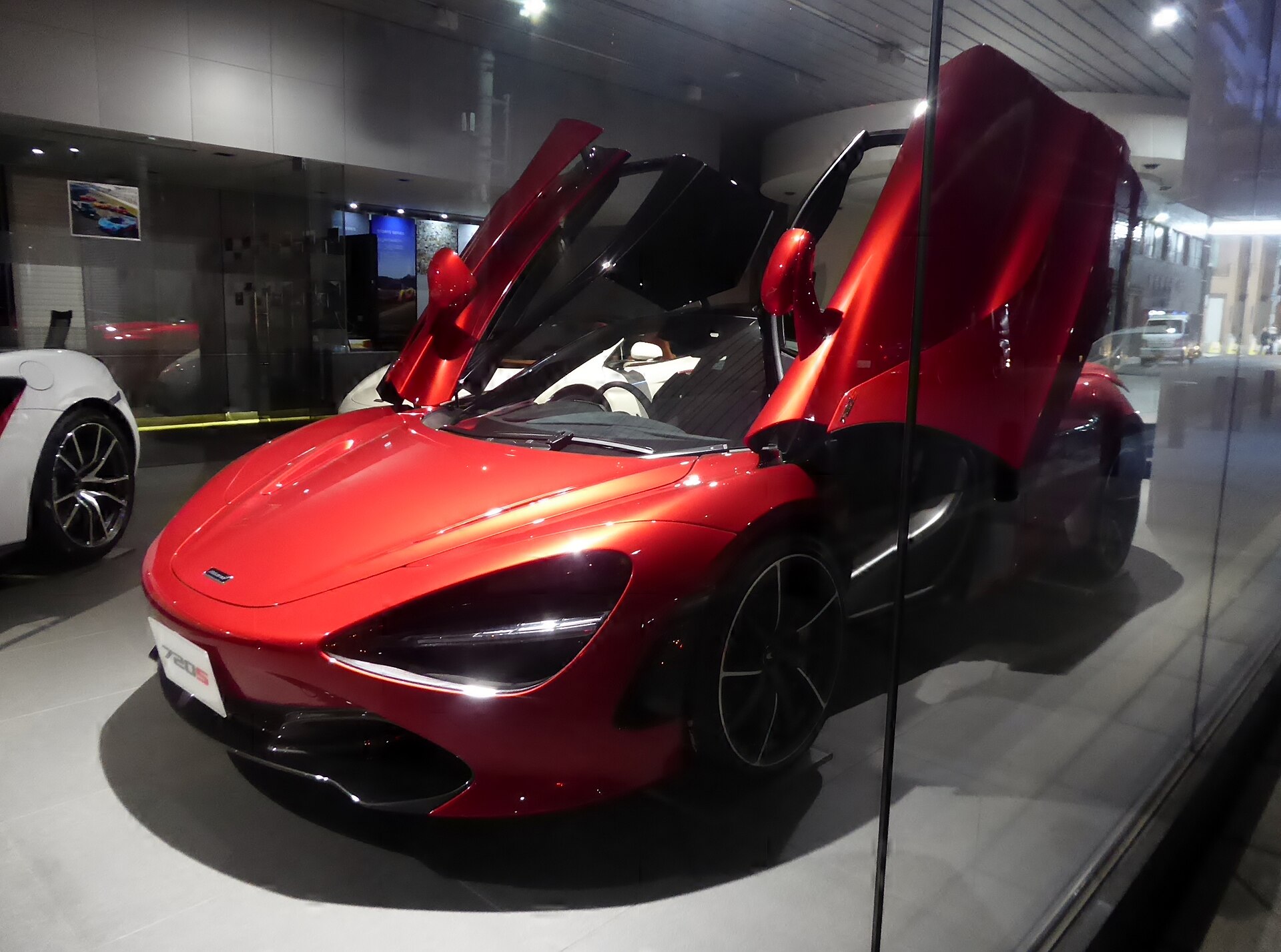 Red McLaren 720S coupe with dihedral doors open